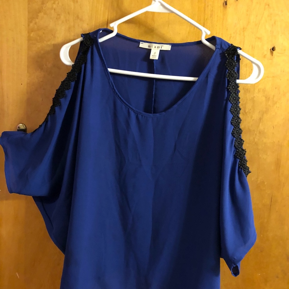 Blue top with black lace detail. Shoulder cut out